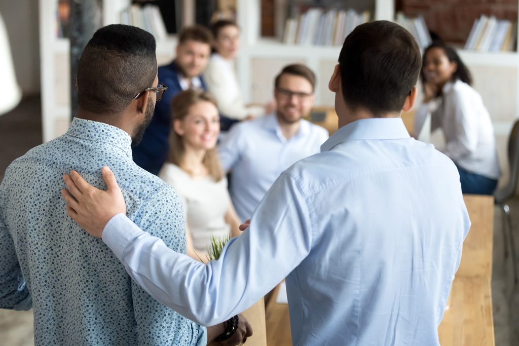 Boss introducing new worker to workmates